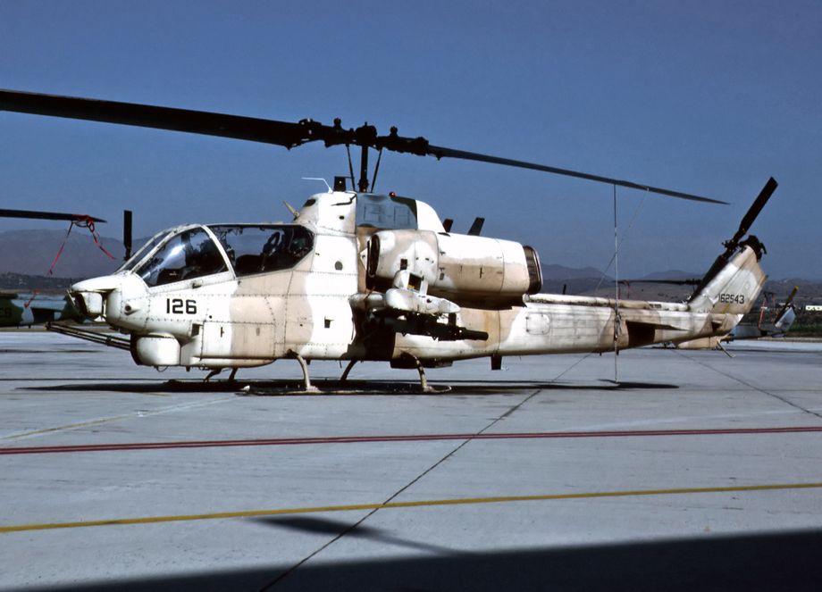 HMLA-367 “Scarface” deployed, as part of MAG-16 to King Abdul Aziz Naval Base, Saudi Arabia.  AH-1W 162543/126 belonging to HMLA-367 is seen here at Camp Pendleton wearing a camouflage quoted by some as being Brown FS30117 and Sand FS33711. “Scarface” recorded the first ever “Whisky” Cobra tank kill at the Battle of “Al Elbow” on Jan 30 1991. They went on to accrue more confirmed kills than any other operational combat squadron during Desert Shield/Storm, including 48 tanks, 24 APCs and 23 other troop transports. Photo © M. Hopper.