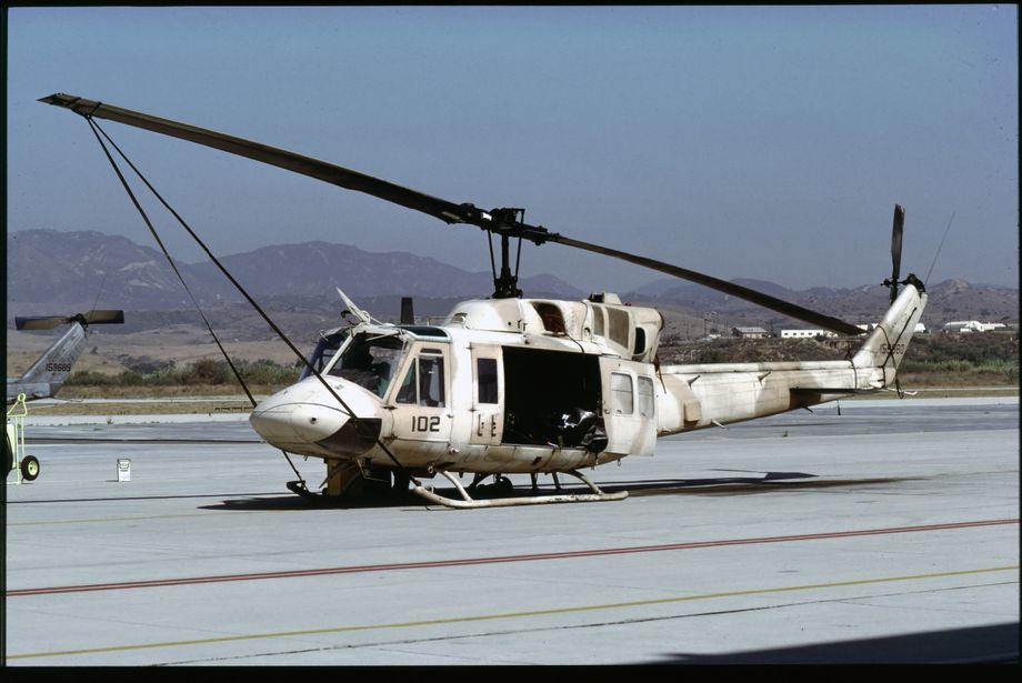 Along with the attack units, all of the HMLA units deployed large numbers of UH-1N “Hueys”.  Some of these sported rather nice desert camouflage schemes like this UH-1N 159680/102 of HMLA-367.  Photo © M. Hopper.