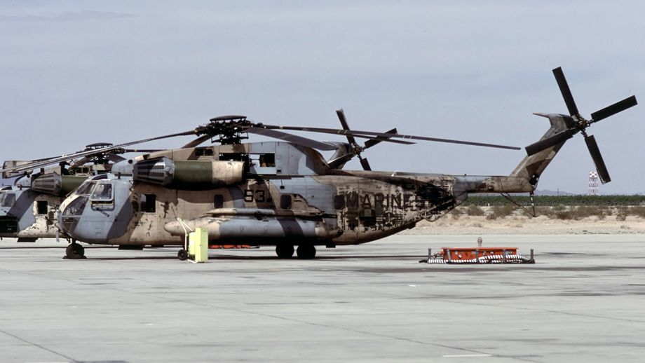 MCAS Tustin based CH-53E 162482/YK/63 from HMH-466 “Wolfpack” was seen here at MCAS Yuma. Wolfpack was the first CH-53E squadron to deploy to the Gulf, to Ras Al Gar, Saudi Arabia as part of MAG-16. HMH-466 was active from the start of Desert Shield/Storm where they recovered downed aircraft, conducted the first Night Vision Goggle (NVG) troop insertion, and provided heavy lift support from port facilities to staging areas in preparation for the ground phase of the operation. Interesting camo pattern too!  Photo © M. Hopper.